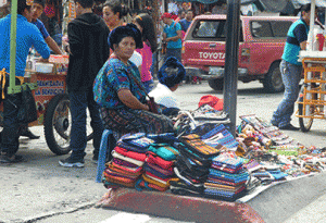 Pictured is a street vendor selling textiles in Guatemala.